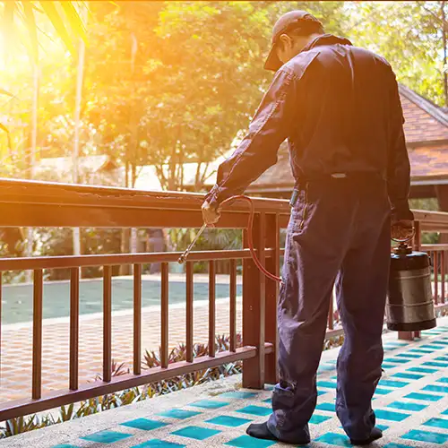 Pest control technician treating a patio - Keep pests away from your home with Vermont Pest Control in Middletown Springs, VT