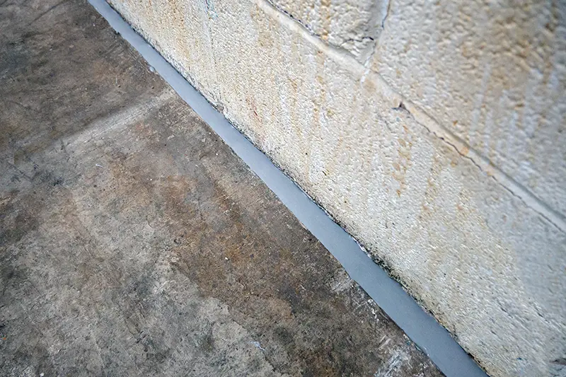 Filled crack space in-between the bricks of a wall & concrete flooring, perfect for Vermont Pest Controls Flexi Armour protection.